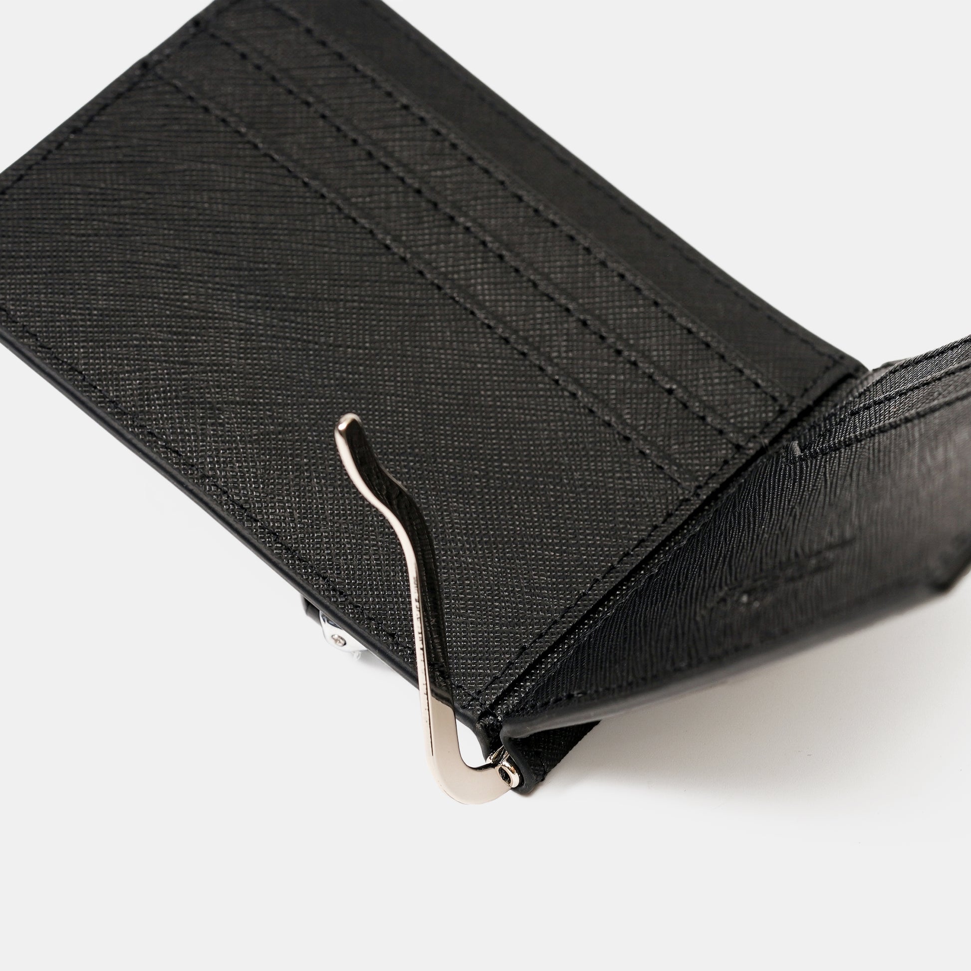 黑 Saffiano 十字紋，特寫角度，簡約背景。FREED 客製化刻字。