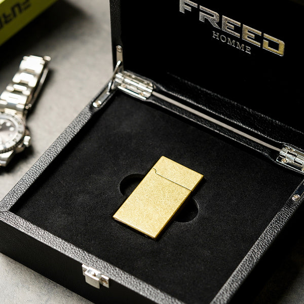 金色滾花銅殼，置於黑色禮盒中，FREED 客製化刻字。